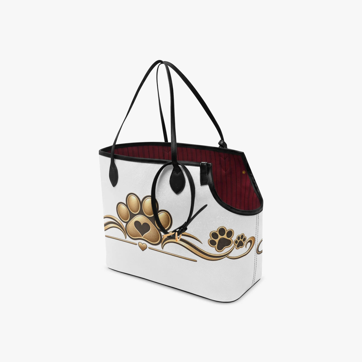 Angled rear view of the white pet carrier tote with gold paw-and-heart artwork, black handles and burgundy lining.